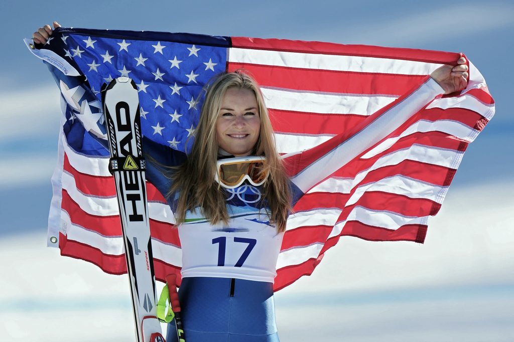lindsey-vonn-ski-racing-record Comeback Queen Lindsey Vonn raising an American flag after a ski racing victory